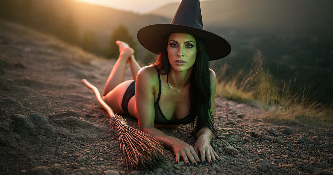 Halloween boudoir with a sexy witch in black lingerie and a witches hat and her broomstick with the golden hour peaking through the mountain backdrop.