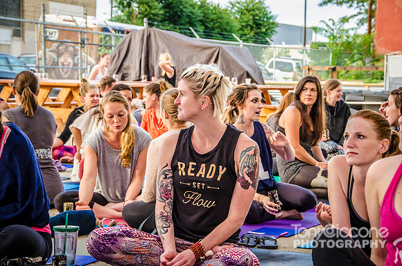 Yoga girl with tattoos at an outdoor yoga class event
