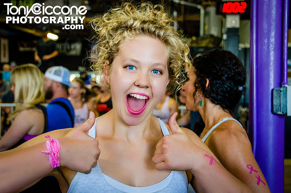 Denver Fitness Photographer at Girls Gone Rx taking photos of blonde crossfit girl giving a thumbs up at crossfit competition.