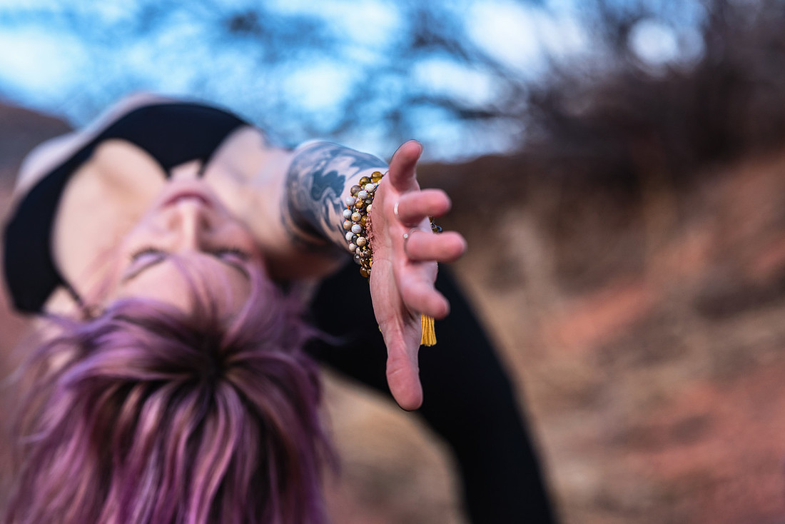 Best yoga photos #20 -  Yoga girl with purple hair and black yoga pants doing a wild thing pose.