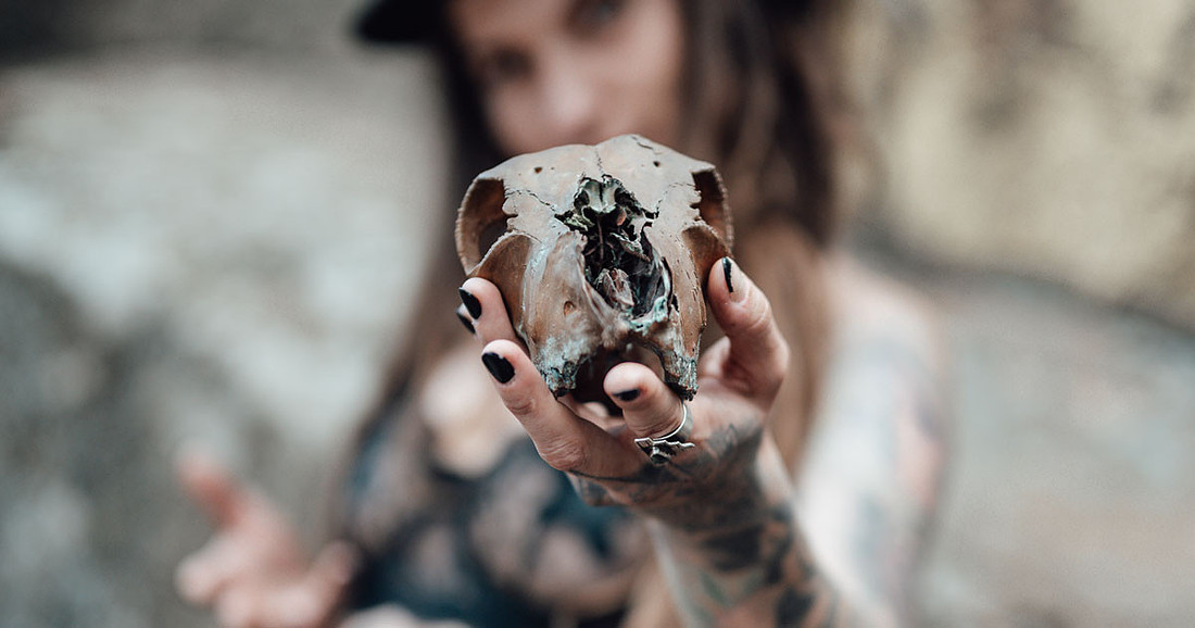 Girl With Tattoos & Dreadlocks Holding Animal Skull Prop.